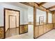 Open room showcasing wood paneling, and views to the foyer and dining area at 2612 Spring St, Dacula, GA 30019