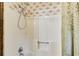 Shower area boasts detachable shower head, shower caddy, and shower curtain at 2612 Spring St, Dacula, GA 30019