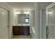 Bathroom with a double vanity, dark cabinets, a walk-in shower, and a separate soaking tub at 3393 Sardis Bend Dr, Buford, GA 30519
