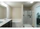 Bathroom with a double vanity, dark cabinets, a walk-in shower, and a separate soaking tub at 3393 Sardis Bend Dr, Buford, GA 30519