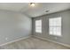 Cozy bedroom with two windows, carpet flooring, and neutral paint at 3393 Sardis Bend Dr, Buford, GA 30519