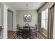 Comfortable dining area features a wooden table, chandelier and backyard views at 3393 Sardis Bend Dr, Buford, GA 30519