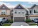 Charming brick townhome with a two-car garage and meticulously maintained landscaping at 3393 Sardis Bend Dr, Buford, GA 30519