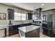 Well-equipped kitchen with granite countertops, dark cabinetry, and stainless steel appliances at 3393 Sardis Bend Dr, Buford, GA 30519