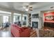Cozy living room featuring a fireplace, hardwood floors, and ample natural light at 3393 Sardis Bend Dr, Buford, GA 30519