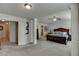 Spacious primary bedroom with a ceiling fan, decorative columns, and neutral carpeting at 3393 Sardis Bend Dr, Buford, GA 30519
