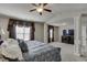 Large primary bedroom featuring a tray ceiling, windows with curtains, and neutral carpeting at 3393 Sardis Bend Dr, Buford, GA 30519
