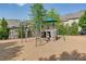 Community playground featuring a climbing structure, swings, and slide, all on a wood chip surface at 3393 Sardis Bend Dr, Buford, GA 30519