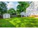 A well-maintained backyard with lush green grass and a storage shed at 350 Birch Rill Dr, Alpharetta, GA 30022