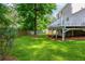 Lush green backyard with a deck and mature trees at 350 Birch Rill Dr, Alpharetta, GA 30022