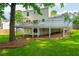 Exterior of home with large deck, ample backyard space, mature trees, and well-manicured lawn at 350 Birch Rill Dr, Alpharetta, GA 30022