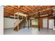 Spacious unfinished basement area with stairway, exposed ceiling, and access to the outside at 350 Birch Rill Dr, Alpharetta, GA 30022