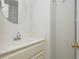 Bathroom with white vanity, round mirror, and gold hardware offers a clean aesthetic at 350 Birch Rill Dr, Alpharetta, GA 30022