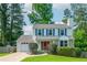 Charming two-story home featuring blue shutters, an orange door, and a well-manicured lawn at 350 Birch Rill Dr, Alpharetta, GA 30022