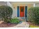 Close-up of a front door with blue shutters, stone pathway, and lush landscaping at 350 Birch Rill Dr, Alpharetta, GA 30022