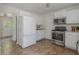 Bright kitchen features stainless appliances, white cabinets, and a view to the entry at 350 Birch Rill Dr, Alpharetta, GA 30022