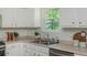 Bright kitchen with stainless steel appliances, white cabinets, and view from window at 350 Birch Rill Dr, Alpharetta, GA 30022