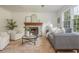 Inviting living room with stone fireplace, neutral decor, and large windows offering natural light at 350 Birch Rill Dr, Alpharetta, GA 30022