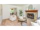 Comfortable living room with fireplace, neutral carpet, and view of dining room at 350 Birch Rill Dr, Alpharetta, GA 30022