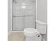 Modern bathroom featuring a toilet and a glass-enclosed shower with built-in shelving at 4197 Chadds Xing, Marietta, GA 30062