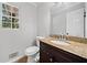 Cozy bathroom featuring dark cabinets with granite countertops and a window at 4197 Chadds Xing, Marietta, GA 30062