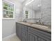 Bathroom featuring double sinks, granite countertop, gray cabinets, and marble tile at 4197 Chadds Xing, Marietta, GA 30062