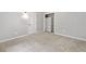 Bright bedroom with plush carpet, door to hallway, and closet with shelving at 4197 Chadds Xing, Marietta, GA 30062