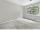 Bedroom with large window offering natural light and neutral colored carpet at 4197 Chadds Xing, Marietta, GA 30062