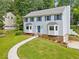 Well-maintained two-story home with blue shutters, a walkway, and landscaped front yard on a sunny day at 4197 Chadds Xing, Marietta, GA 30062