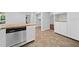View of the stainless steel dishwasher surrounded by white cabinets and butcher block countertops at 4197 Chadds Xing, Marietta, GA 30062