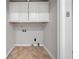 A convenient laundry room offering white cabinets and tile floors at 4197 Chadds Xing, Marietta, GA 30062