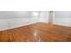 Living room with shiny hardwood floors, white trim, and an open doorway at 4197 Chadds Xing, Marietta, GA 30062