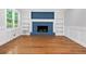 Inviting living room boasting hardwood floors, fireplace with shelving, and ample natural light at 4197 Chadds Xing, Marietta, GA 30062
