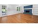 Spacious living room featuring hardwood floors, a fireplace, and wainscoting at 4197 Chadds Xing, Marietta, GA 30062