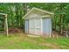 Outdoor storage shed with double doors surrounded by lush greenery at 4197 Chadds Xing, Marietta, GA 30062