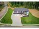 Aerial of modern home on a spacious lot with green lawn and driveway at 52 Deer Canyon Dr, Auburn, GA 30011