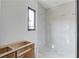 Bathroom with a frameless glass shower and a small window for natural light at 52 Deer Canyon Dr, Auburn, GA 30011