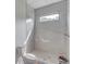Modern bathroom with sleek white marble walls and a window for natural light at 52 Deer Canyon Dr, Auburn, GA 30011
