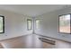 Bright bedroom with light wood flooring and multiple windows overlooking a wooded area at 52 Deer Canyon Dr, Auburn, GA 30011