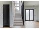 Bright entryway with hardwood floors, staircase and large windows providing natural light at 52 Deer Canyon Dr, Auburn, GA 30011