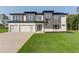 Modern two-story home featuring a spacious three-car garage and a lush green lawn at 52 Deer Canyon Dr, Auburn, GA 30011