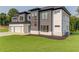 Modern two-story home with three-car garage, well-maintained lawn and mature trees at 52 Deer Canyon Dr, Auburn, GA 30011