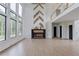 Bright living room features a modern fireplace, hardwood floors and high ceilings at 52 Deer Canyon Dr, Auburn, GA 30011