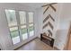 Bright living room featuring a modern fireplace and expansive windows with outdoor views at 52 Deer Canyon Dr, Auburn, GA 30011
