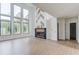 Open-concept living room featuring tall windows, hardwood floors, and modern fireplace at 52 Deer Canyon Dr, Auburn, GA 30011