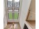 Staircase with light wood treads and large windows offering a view of the outdoors at 52 Deer Canyon Dr, Auburn, GA 30011