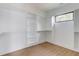 Bright walk-in closet with custom white shelving and cabinets for optimal storage at 52 Deer Canyon Dr, Auburn, GA 30011