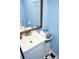 Bathroom vanity with a white sink, wood-framed mirror, and black-and-white checkered flooring at 852 Glynn Oaks Dr, Clarkston, GA 30021