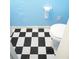 Bathroom featuring a toilet and black and white checkered flooring, creating a classic design at 852 Glynn Oaks Dr, Clarkston, GA 30021