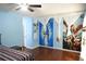 Bright primary bedroom featuring wood floors and bright blue walls with art at 852 Glynn Oaks Dr, Clarkston, GA 30021